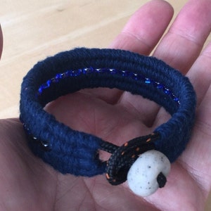 navy blue beaded cotton cuff bracelet in hand by WhatKnotShop on ETSY