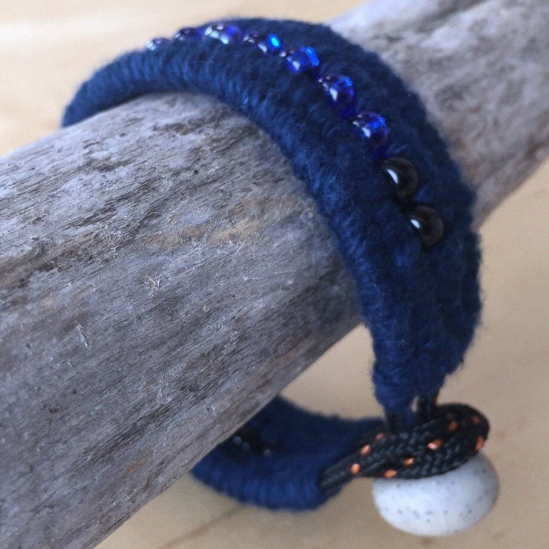 navy blue beaded cotton cuff bracelet featuring granite clay button on display bar by WhatKnotShop on ETSY