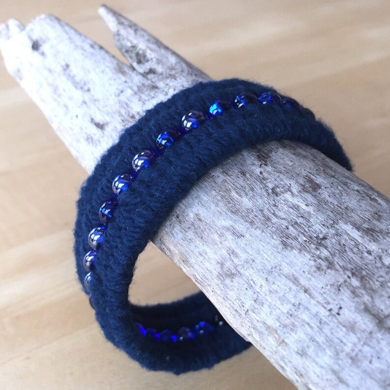 navy blue beaded cotton cuff bracelet on display bar by WhatKnotShop on ETSY