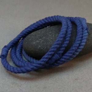 four blue string rope bracelets posed on grey stone by WhatKnotShop on ETSY