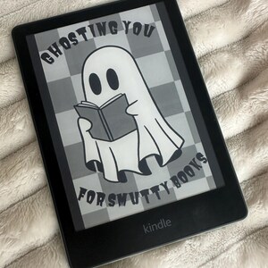 May include: A black and white image on a Kindle e-reader. The image shows a ghost reading a book with the text "Ghosting you for smutty books".