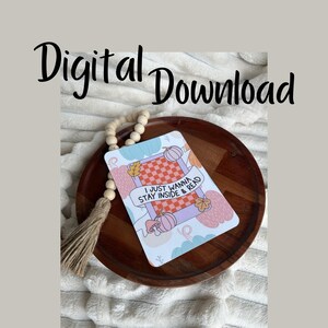 May include: A digital download printable featuring a pink and orange pumpkin with the text "I just wanna stay inside & read" in a white banner.