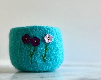 Bright blue felted wool bowl with purple button flowers