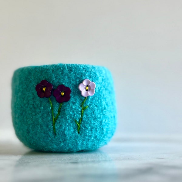 Bright blue felted wool bowl with purple button flowers