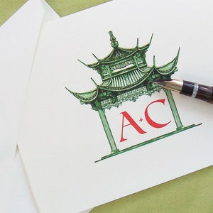 May include: A green and red illustration of a pagoda with the initials "A.C." in red.