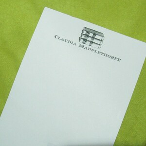 May include: White stationery with a black and white logo of a stack of books and the text "CLAUDIA MAPPLETHORPE"