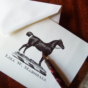 May include: A black and white illustration of a horse jumping over a striped hurdle. The text "Liza W. Marshall" is printed below the image.