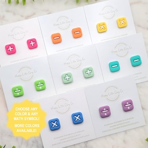 May include: Colorful polymer clay earrings in various colors, each featuring a different math symbol. The earrings are displayed on white cards with the text "Happy Little Clay Co." and "Choose any color & any math symbol! More colors available!"