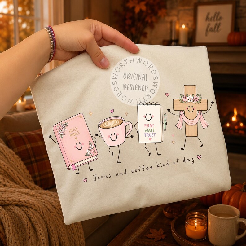 May include: A cream-colored fabric item featuring a graphic of a smiling pink Holy Bible, a pink coffee cup, a white notepad with the text PRAY WAIT TRUST, and a wooden cross with a pink scarf. The text Jesus and coffee kind of day is printed below.