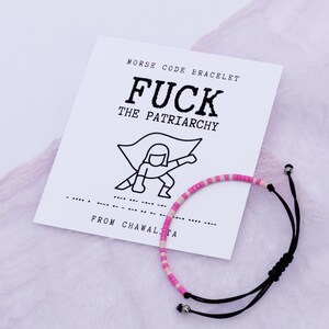 May include: A black and white illustration of a superhero with the text "FUCK THE PATRIARCHY" above it. A pink and white beaded bracelet with black string is on a white card with the text "MORSE CODE BRACELET" and "FROM CHAWALTA" on it.
