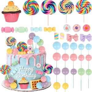 May include: A set of cake toppers featuring a light blue cake with pink icing drip and the text Happy Birthday, surrounded by miniature candy-themed decorations including rainbow lollipops, pastel balloons, cupcakes, donuts, and bows.