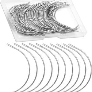 May include: A collection of curved, silver-colored needles, some neatly arranged in a clear plastic container, and others displayed below. The needles have a curved shape with a small eye at one end, suitable for sewing or crafting projects.