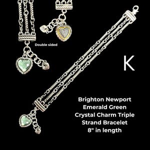 May include: A triple-strand silver bracelet with emerald green crystal heart charms. The bracelet is 8 inches in length and features the text "Brighton Newport Emerald Green Crystal Charm Triple Strand Bracelet".