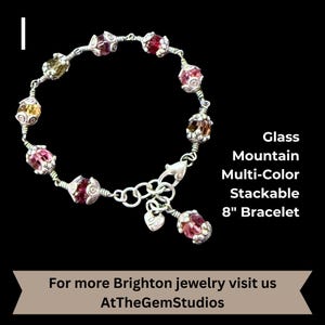 May include: A multi-color glass bead bracelet with silver-tone metal accents. The bracelet is 8 inches long and features a variety of colorful beads. Text on the image reads "Glass Mountain Multi-Color Stackable 8" Bracelet."