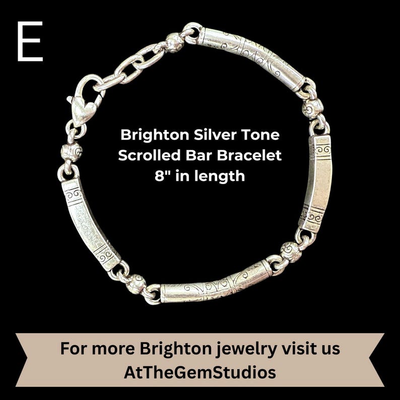 May include: Brighton silver tone scrolled bar bracelet, 8 inches in length. The bracelet features a series of curved, engraved bars connected by smaller, decorative links. The clasp is a heart-shaped lobster claw. The text "Brighton Silver Tone Scrolled Bar Bracelet 8" in length" is visible.