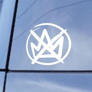 May include: White vinyl car decal featuring a stylized crown design within a circle. The graphic is applied to the rear window of a black vehicle, offering a clean, minimalist aesthetic. The design is suitable for car enthusiasts.