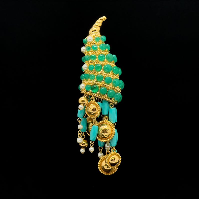 May include: A gold and green statement earring with a spiral design and turquoise and pearl accents.
