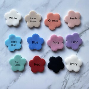 May include: Twelve flower-shaped silicone molds in various colors, including white, latte brown, orange, peach, baby blue, blue, pink, lilac, teal green, red, black, and ivory.