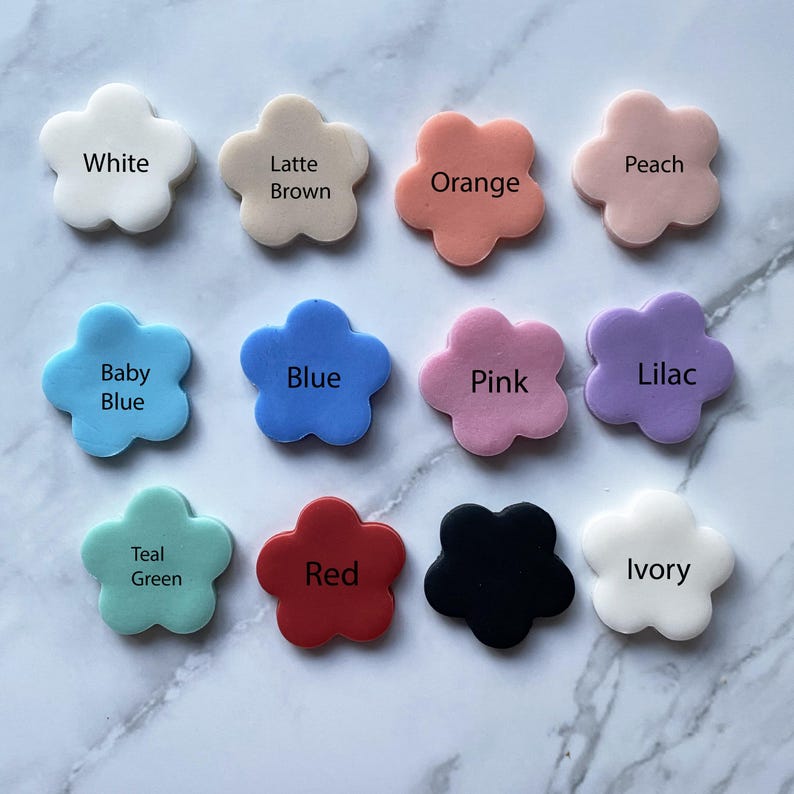 May include: Twelve flower-shaped silicone molds in various colors, including white, latte brown, orange, peach, baby blue, blue, pink, lilac, teal green, red, black, and ivory.