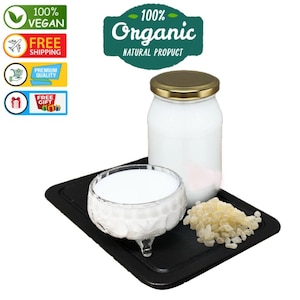 May include: A white jar with a gold lid, a small glass bowl, and a pile of light-colored granules sit on a black tray. The jar and bowl are filled with a white liquid. Text on the image reads "100% Vegan", "Free Shipping", "Premium Quality", "Free Gift", and "100% Organic Natural Product."