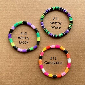 May include: Three colorful beaded bracelets. One bracelet features green, purple, black, and gold beads. Another bracelet has a mix of pink, orange, yellow, and black beads. The third bracelet has green, purple, black, and gold beads. Each bracelet has text.