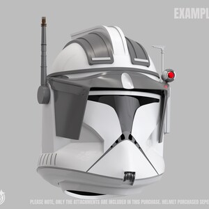 May include: A white and grey helmet with black visor details, a red light, and an antenna. The word "EXAMPLE" is printed at the top right. The text at the bottom says, "PLEASE NOTE, ONLY THE ATTACHMENTS ARE INCLUDED IN THIS PURCHASE. HELMET PURCHASED SEPERATELY."