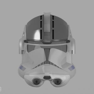 May include: A white and gray helmet with a transparent visor and blue accents. The helmet has a rounded top and a detailed front design, featuring two eye-like openings and a central, rectangular feature.
