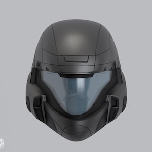 May include: A matte black helmet with a blue-tinted visor. The helmet has a futuristic design with angular features and a smooth, seamless finish. The visor is curved and covers the face area. The helmet appears to be a prop or costume piece.