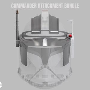 May include: A gray Commander Attachment Bundle, with the text "COMMANDER ATTACHMENT BUNDLE" at the top. The bundle includes a helmet with a red light, antenna, and other attachments. The helmet is transparent with gray accents.