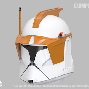 May include: A white and orange helmet with a black visor, antenna, and red accents. The helmet has the word "EXAMPLE" printed on the top right. The text at the bottom reads "PLEASE NOTE, ONLY THE ATTACHMENTS ARE INCLUDED IN THIS PURCHASE. HELMET PURCHASED SEPERATELY."