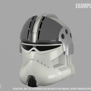 May include: A white and gray helmet with a black visor and accents. The helmet has a rounded shape with vents and a chin piece. The word "EXAMPLE" is printed on the top right. The text at the bottom says "PLEASE NOTE, ONLY THE ATTACHMENTS ARE INCLUDED IN THIS PURCHASE. HELMET PURCHASED SEPERATELY."