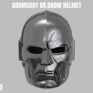 Op de afbeelding: Een grijze Doomsday Dr. Doom helm met een gespleten ontwerp. De linkerkant is glad, terwijl de rechterkant mechanische beplating toont met zichtbare klinknagels en naden. De tekst DOOMSDAY DR.DOOM HELMET staat boven het object.