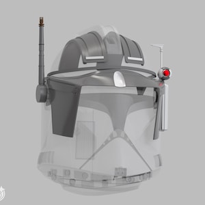 May include: A grey and white helmet with a transparent visor, featuring a prominent antenna and a red light on the side. The helmet has a detailed design with angular shapes and a futuristic aesthetic.
