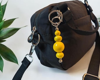 Yellow bag charm and key ring made from upcycled wooden beads.