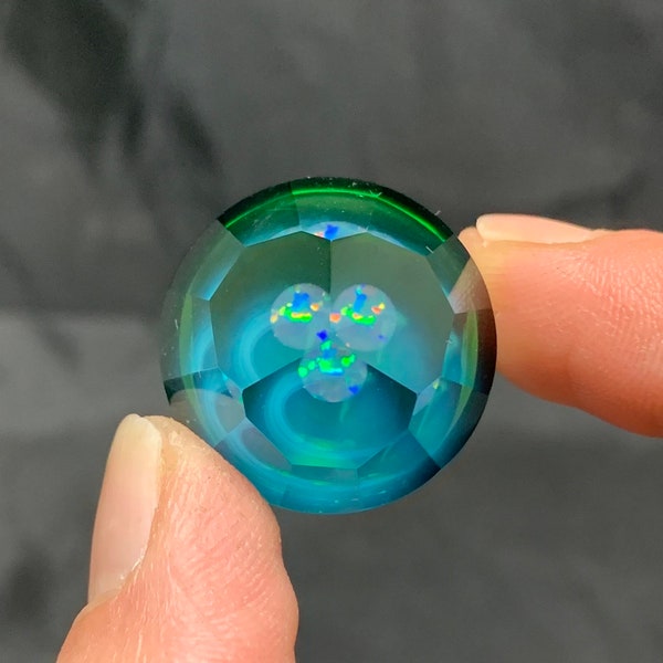 25mm faceted glass marble with Opal coin on plantphibian