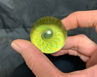 1.5”/38.1mm handmade silver and gold fumed glass marble on galaxy black.
