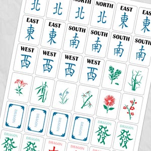 May include: A sheet of white Mahjong tiles with blue and green symbols and characters. The tiles feature directional symbols like East, West, South, and North, along with floral and dragon designs. The word "DRAGON" is also visible.