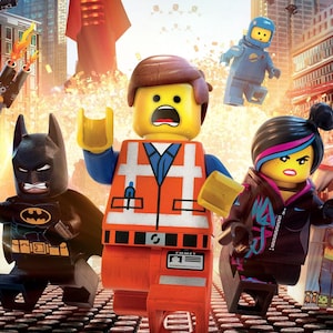 May include: A group of LEGO minifigures including Emmet in an orange vest, Wyldstyle with blue and pink hair, and Batman in a black suit. They are running through a city with tall buildings and explosions in the background, featuring other characters.