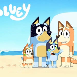 May include: A digital illustration featuring the Bluey logo in white text above four cartoon dogs standing on a sandy beach. The characters include a tall blue dog, a tall red dog, and two smaller blue and red dogs with spots, all smiling.