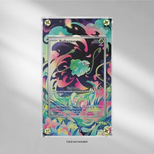 May include: A framed Bulbasaur Pokémon card. The card features a green Bulbasaur character with the text "Bind Down". The frame has a colourful floral design with gold-coloured screws. The text "Card not included" is at the bottom.