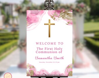 May include: Welcome to the First Holy Communion of Samantha Smith, a white sign with pink and gold watercolor design, a gold cross, and the date and time of the event.