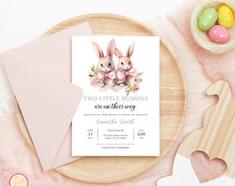 May include: A baby shower invitation with a pink and white color scheme. The invitation features two watercolor bunnies with pink bows and floral accents. The text reads "Two Little Bunnies are on their way" and includes the name "Samatha Smith" and details for the baby shower.