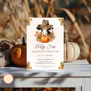 May include: A printable invitation for a child's birthday party. The invitation features a cartoon cow wearing a hat and holding a pumpkin. The text on the invitation reads "Holy Cow Bernadette is turning two, join us to celebrate, Saturday 31st October at 12pm, Big Run Event Center, 202 Thompson St, Big Run, PA 15715, RSVP to Tanya by 5th December at 090 173 3456".