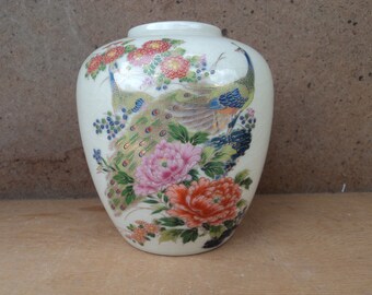 Beautiful vintage porcelain vase with two peacocks among the flower garden pet birds with fancy feathers