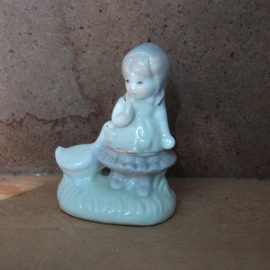 Vintage porcelain figurine little girl with goose eating out of her pocket gold trimmed farm animals