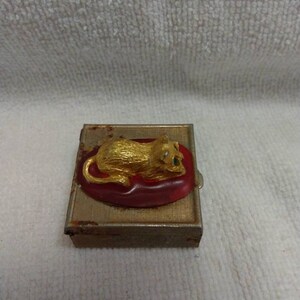May include: A small, rectangular, metal box with a gold finish. The box has a red and gold lion figurine on the lid.