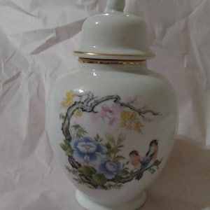 White ceramic ginger jar Japanese cherry tree blue flowers and multicolor lovebirds
