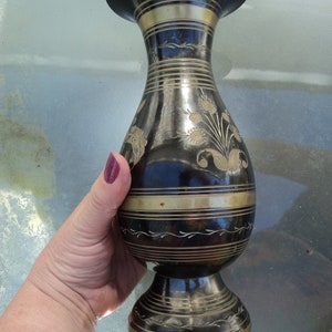 A brass or copper hand carved engraved Indian urn vase.