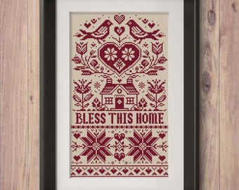Puede incluir: Arte de punto de cruz enmarcado con fondo crema y diseño burdeos. El diseño incluye pájaros, corazones, flores, una casa y el texto "BLESS THIS HOME". La obra de arte está en un marco negro, adecuada para la decoración del hogar.