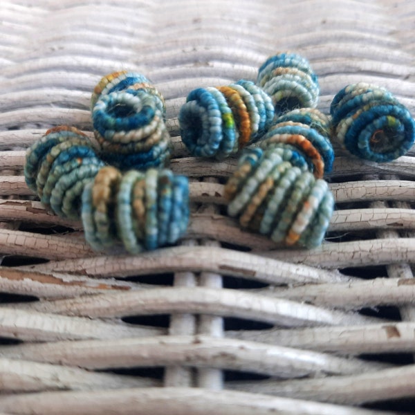 Handmade fiber beads. Multicolor including blue, teal, cream, and tan